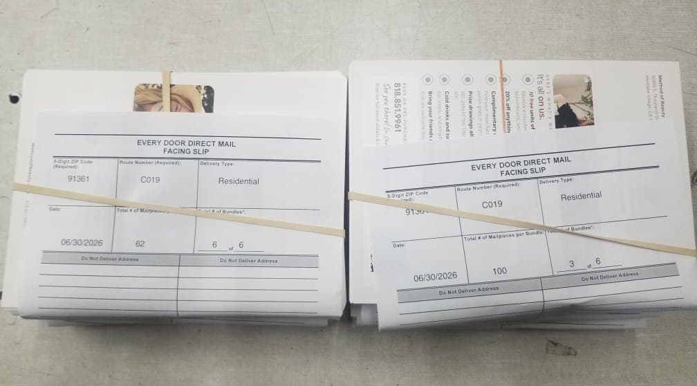 Postcards bundled by carrier route with the USPS facing slips